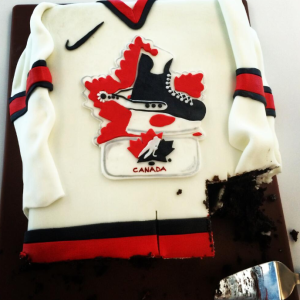 Celebrating early? Delegates at Hockey Canada's 95th AGM enjoy a red and white cake as the organization launches its centennial anniversary celebrations.