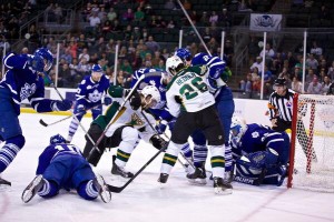 Caption: A battle beside the net as the Stars dominate Game 7 of the AHL Western Conference Semifinals on June 3, 2014 at Cedar Park Center, TX 