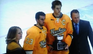 Co-Captains of the Michigan Tech Huskies, Alex Petan and Cliff Watson accept the 2nd place trophy at the 51st Annual Great Lakes Invitational