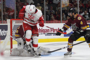 Chicago Goalie Jordan Binnington deflects a shot on goal while Morgan Ellis assists with the defense. Photo courtesy of Mark Newman, Grand Rapids Griffins
